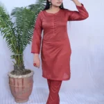 Girl in beautiful plain Maroon dress.