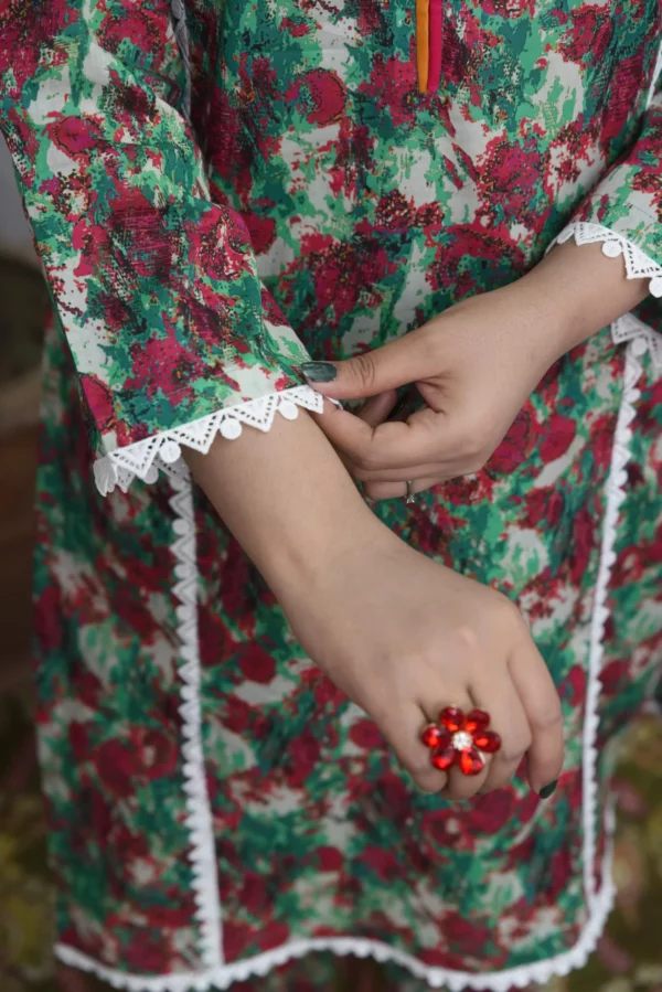 Women in two printed red and green floral design dress